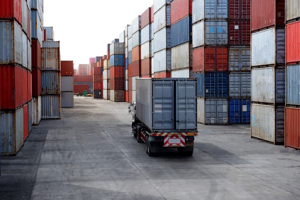Cargo trucks lined up in a container yard, ready for transportation and logistics operations.