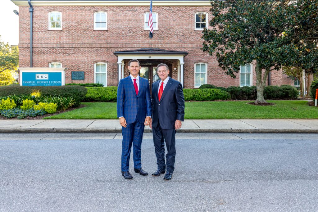 Two attorneys standing outside the Emmanuel Sheppard & Condon office in Pensacola, Florida